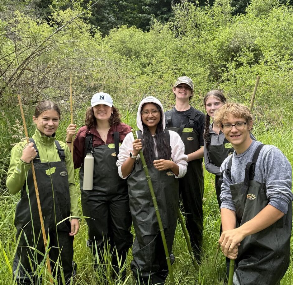 Group of Youth Watershed Council students standing next to a beaver pond.